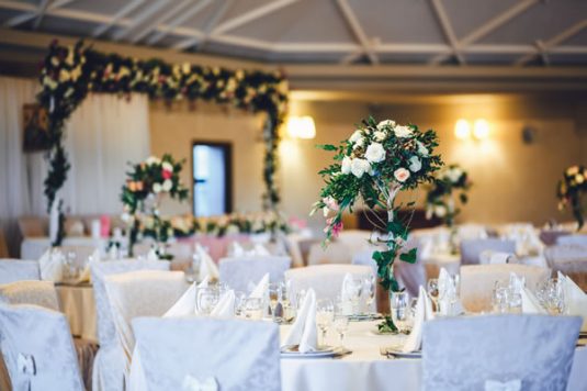 restaurant-hall-with-tables-decorated-with-tall-vases-with-roses